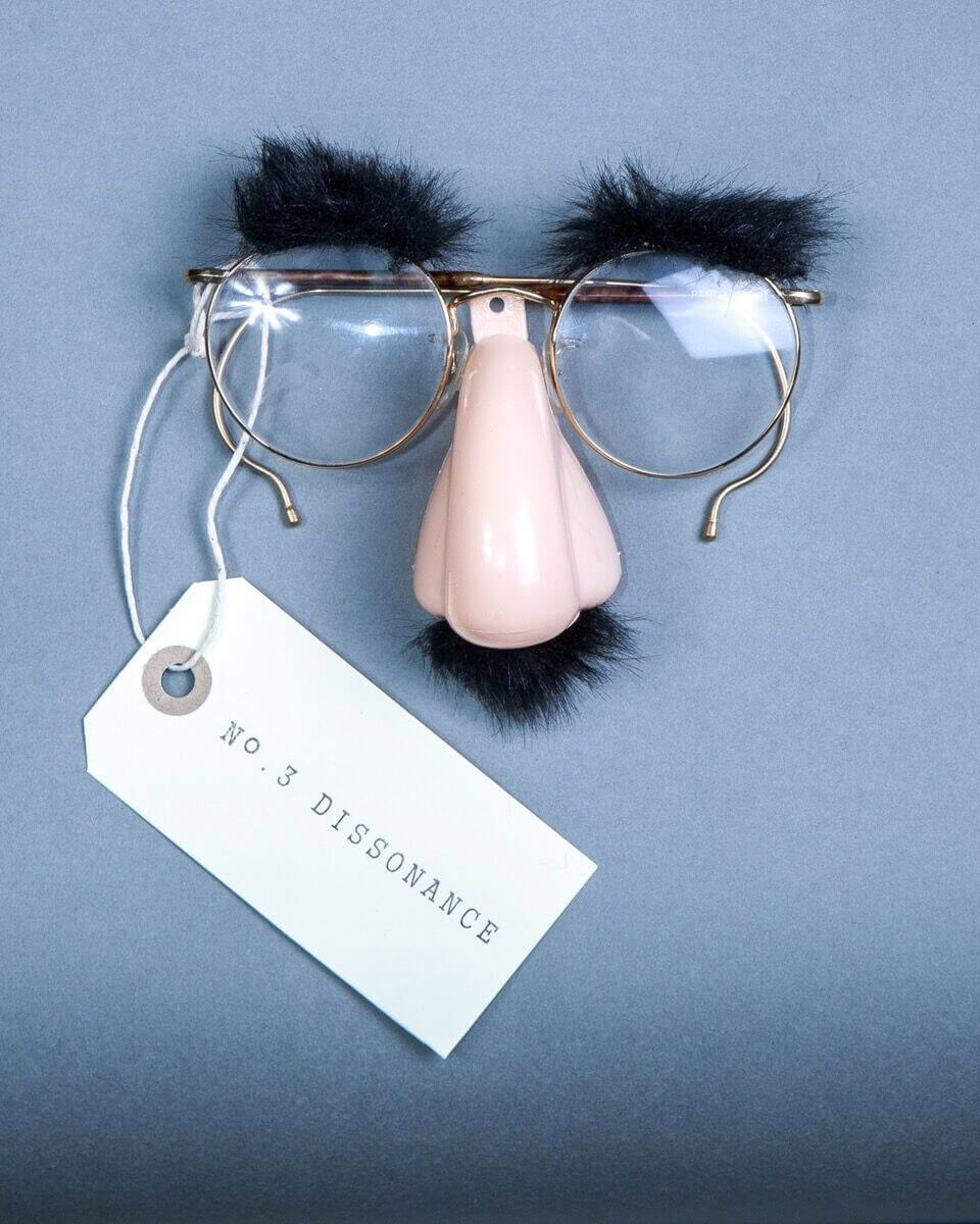 A pair of glasses with a mustache on marked with No. 3 dissonance