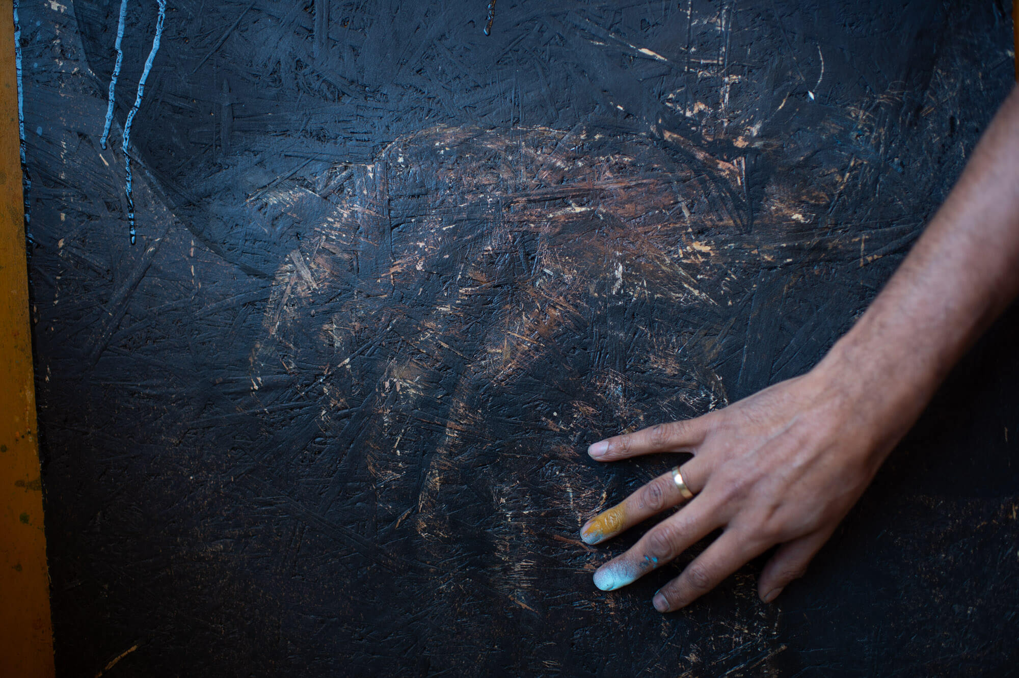 NIMI’s hand on one of his works