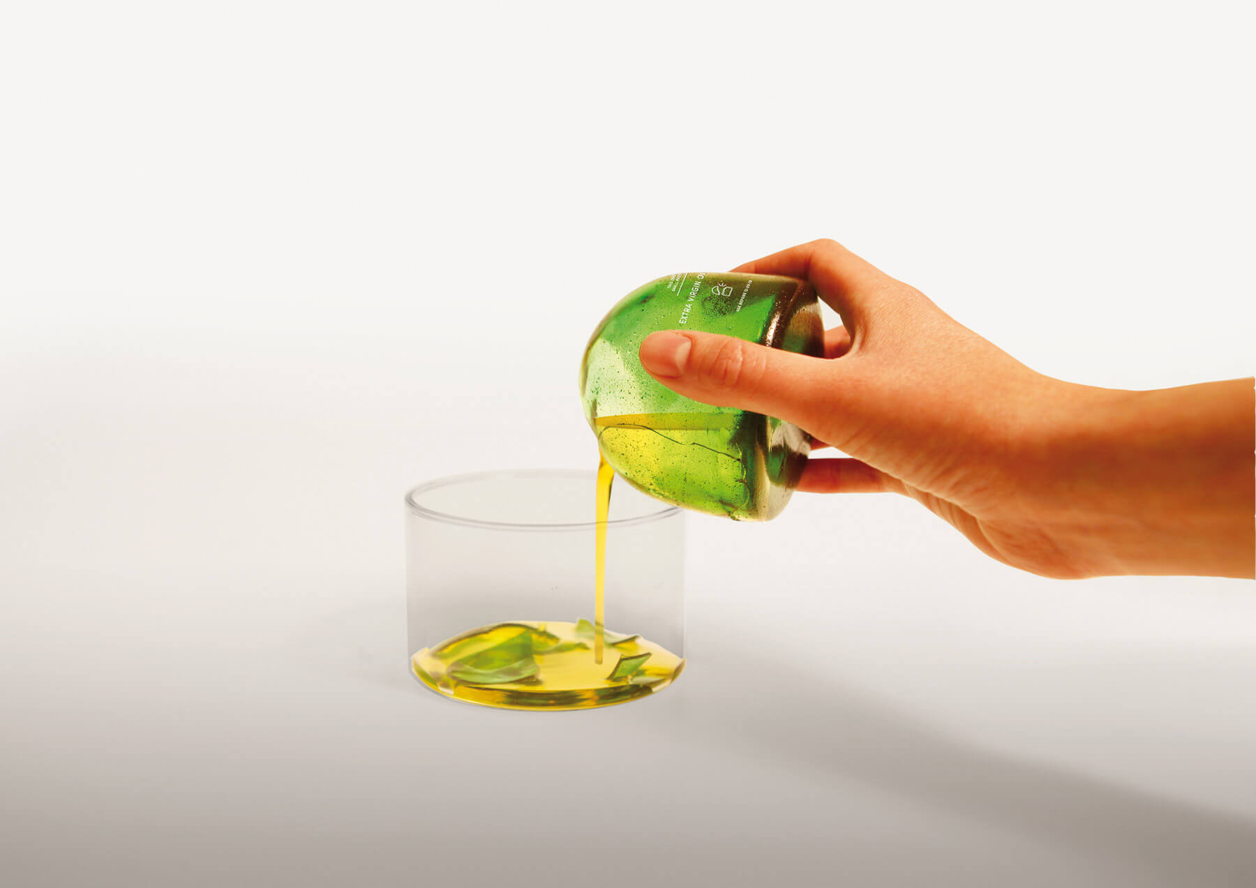 Oil being poured into a glass from the oil package