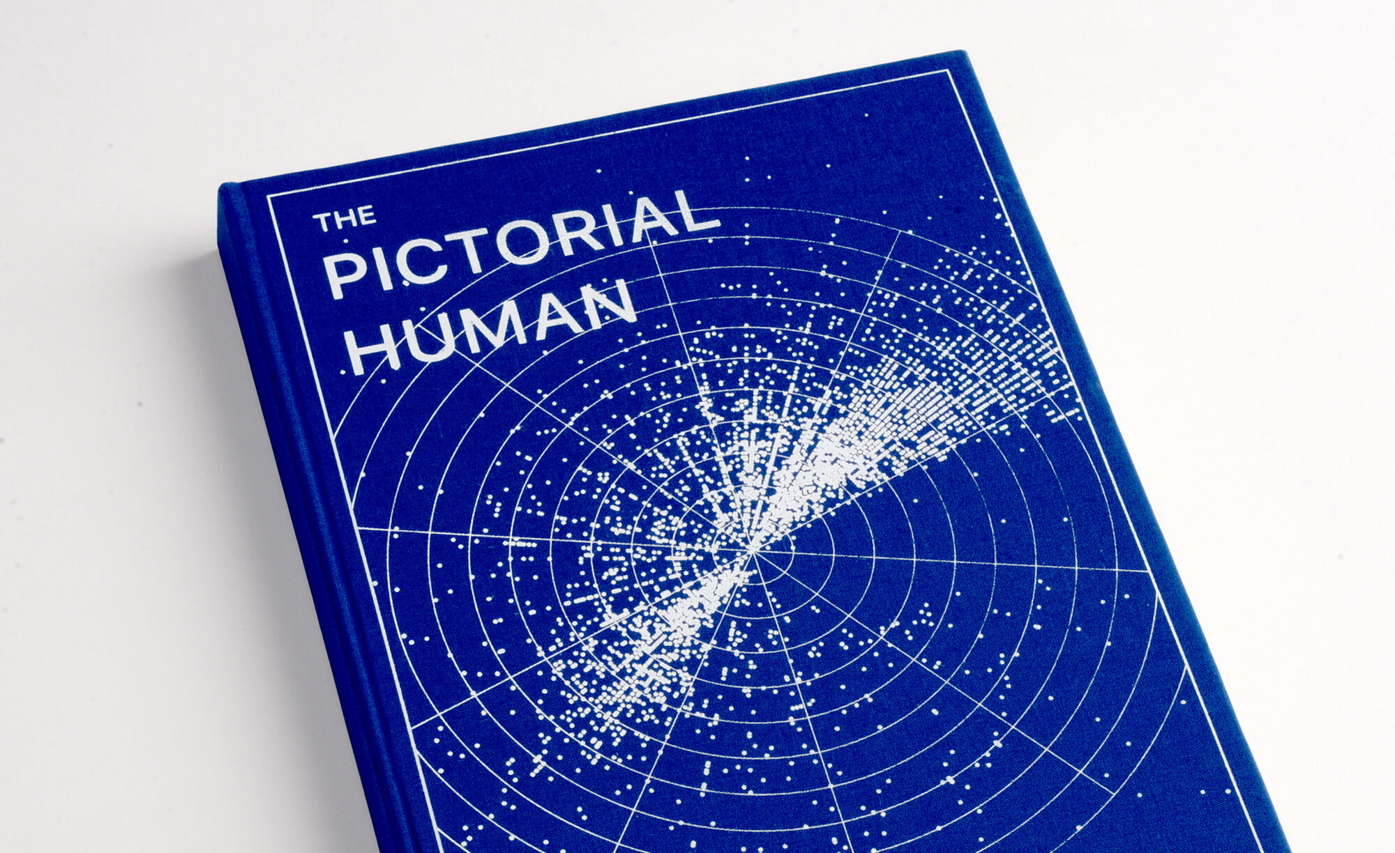 The Pictorial Human blue book cover with white visuals and text